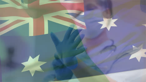 animation of flag of australia over african american female doctor wearing face mask