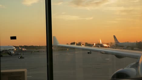 slow motion taxiing of airplanes along the runway ready to take off in the setting sun