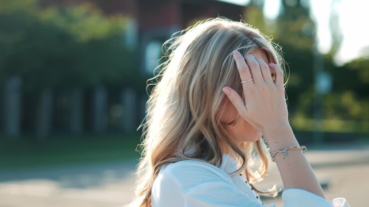 A beautiful young woman laughs very warmly and looks happy orbit shot