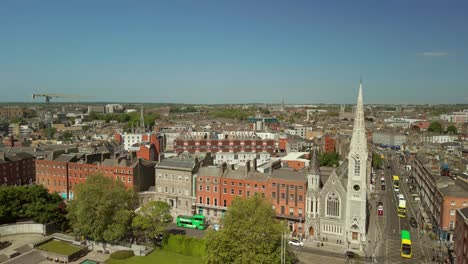 wide reversing aerial video of abbey presbyterian church and the surrounding area in dublin city centre, ireland on a bright and sunny day. filmed in 4k, 60fps and with rec709 color.