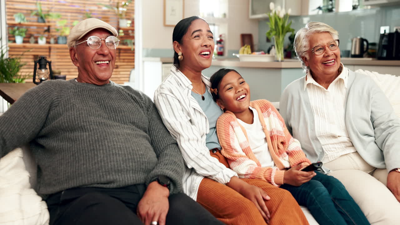 Happy multigenerational family watching TV at home