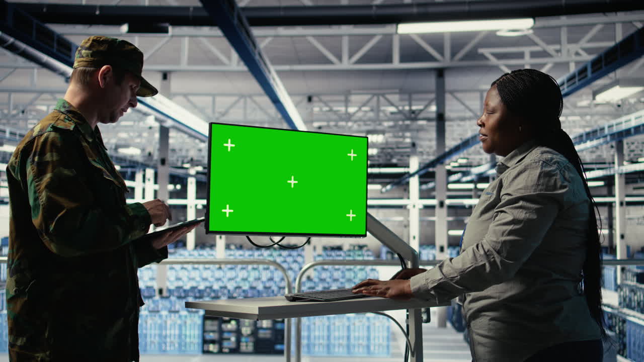 Soldier And Technician In Server Hub Use Green Screen Computer To Manage Systems