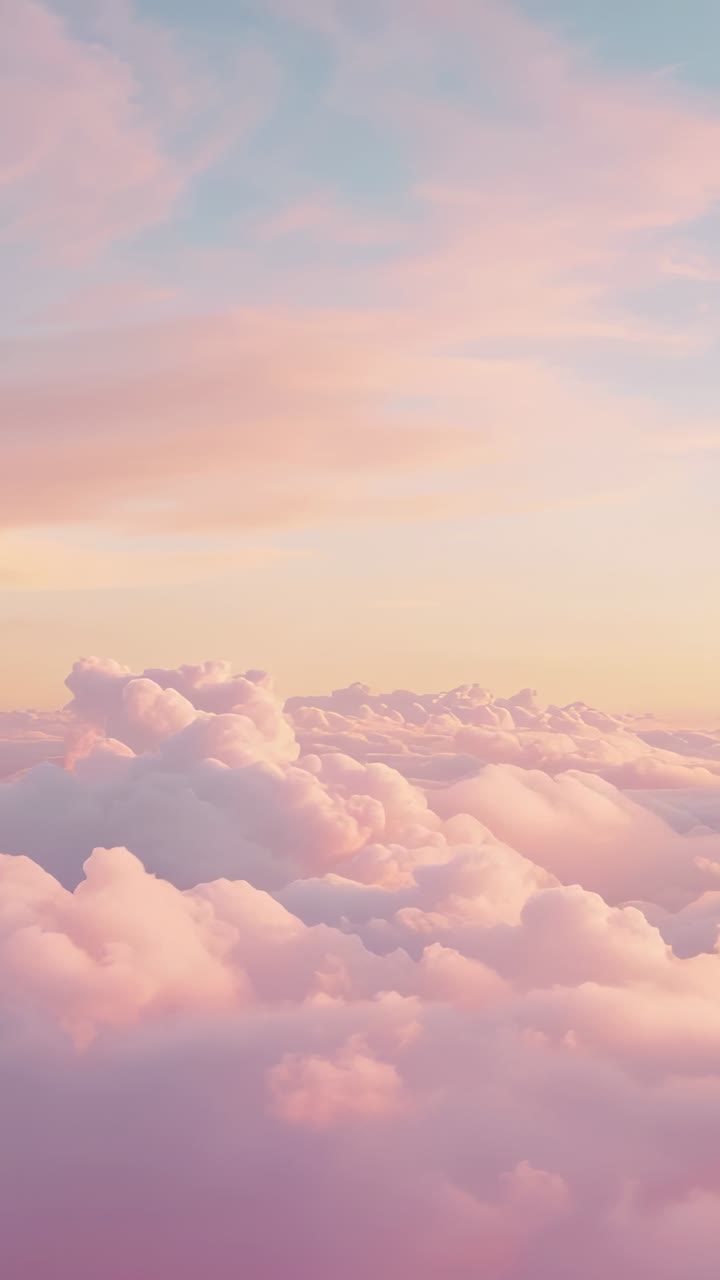 Vertical video: Drifting billowy clouds leftward at high-altitude with sunrise near, shifting color