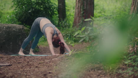 girl practices in a forest long shot