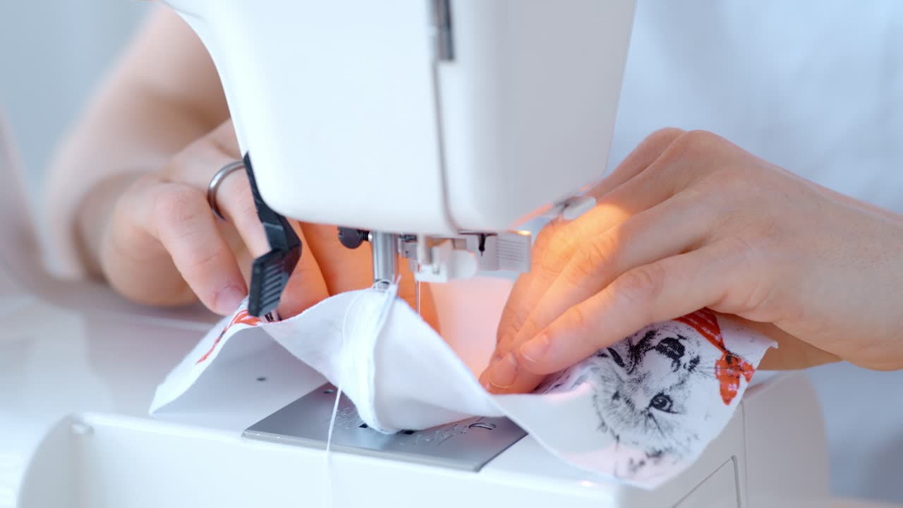 Woman Sewing with a Sewing Machine