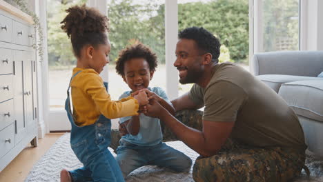 army father in uniform home on leave with children doing jigsaw puzzle together