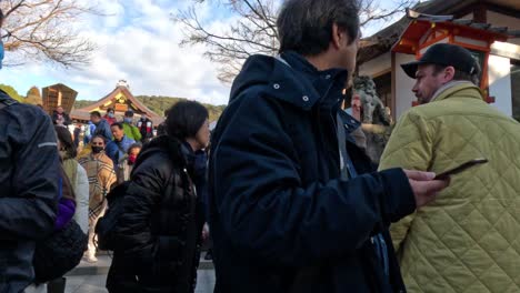 visitors walking and interacting at a temple fair