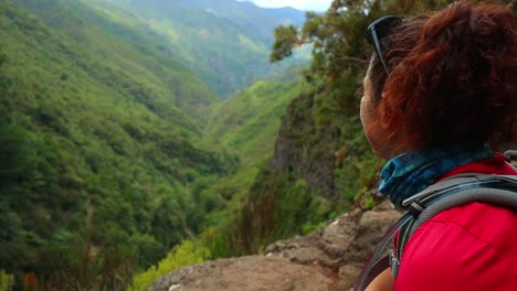 young red-haired girl enjoys the tropical forest landscape from above