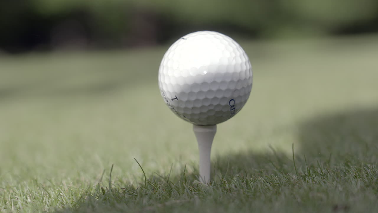 Hands adjusting golf ball on the tee