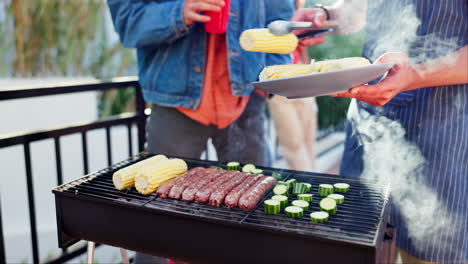 people grilling corn and sausage outdoors