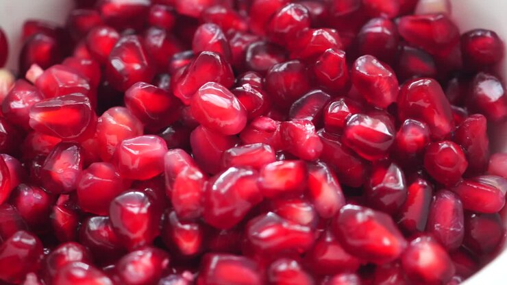 Close up of pomegranate seeds on a bowl on table