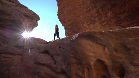 Junge-Frau,-Die-Oben-Auf-Dem-Sandsteinfelsen-In-Der-Atemberaubenden-Landschaft-Des-Colorado-National-Monument-Park-Usa-Spazieren-Geht,-Niedriger-Winkel