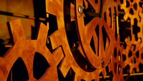 a lot of rotating wooden gears in a huge clock mechanism.