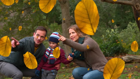 animation of autumn leaves falling over happy caucasian family in park