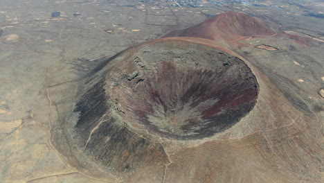 aerial drone panning shot over the the calderón hondo volcano in fuerteventura island