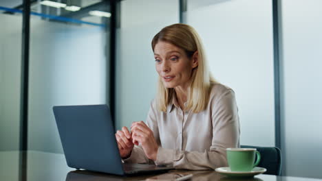 happy executive video chatting laptop workplace closeup. business woman talking