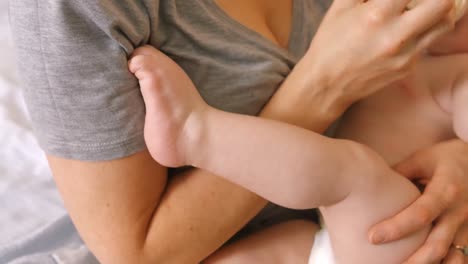 mother feeding milk to her baby