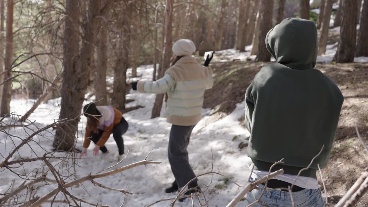 People Having a Snowball Fight in the Forest