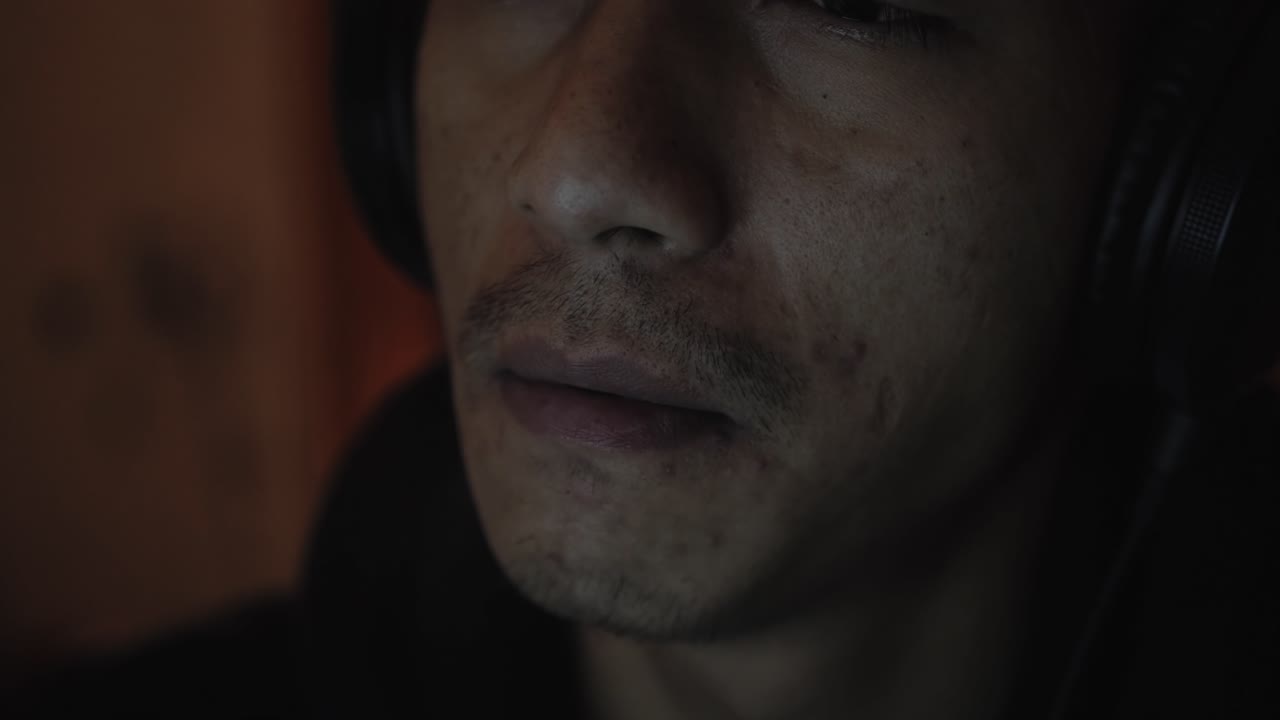 Young man smoking cigarette watching laptop screen. Close up