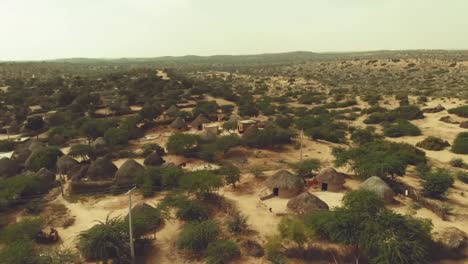 aerial view over tharparkar with rural huts on the ground