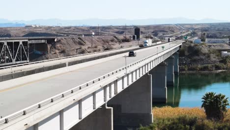 trucks and cars driving over a bridge, colorado river , i-40 freeway east