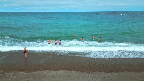 people swimming in the ocean at the beach