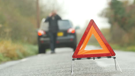 driver broken down calling recovery service on mobile phone