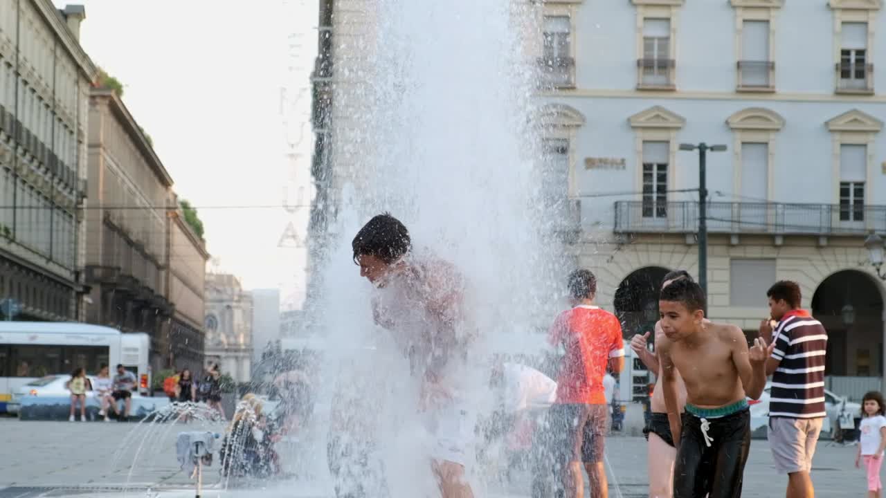 Kids having fun in a fountain. Big heat wave in Europe.