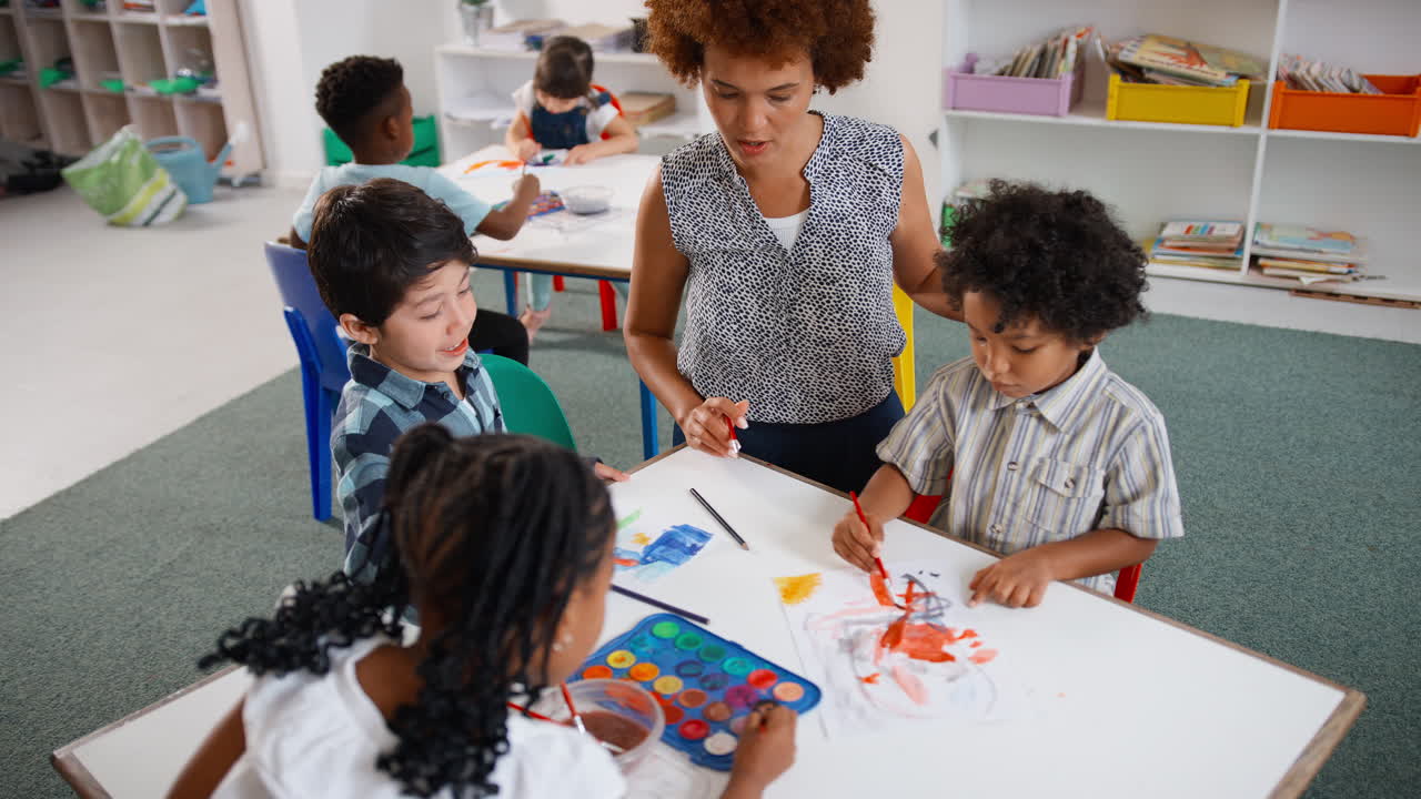maestra con alumnos de escuelas primarias multiculturales en clase de arte en la escuela