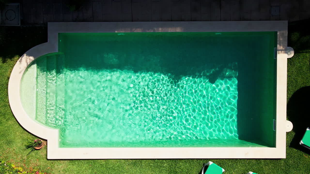 Dramatic zooming out aerial reveal of luxury swimming pool at exclusive Mediterranean villa