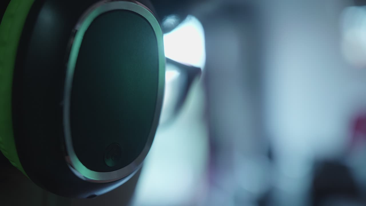 Close-up of Hand Putting On Glowing Headphones
