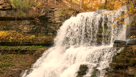 Rapids-Rushing-On-Rocky-Terraced-Cliffs-In-Autumnal-Forest