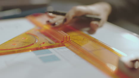 woman working on technical drawing with drawing tools