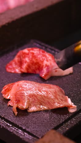 steak being seared on a hot stone grill