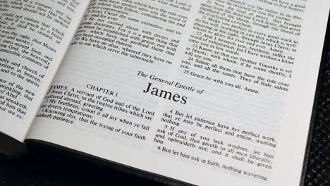 close up shot of bible page turning to the book of james