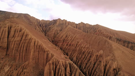 drone shot showcases unique, structured dry hills at ghami, upper mustang, nepal. artistic mountains and hill structures in the backdrop makes video alluring. enchanting landscape of annapurna area