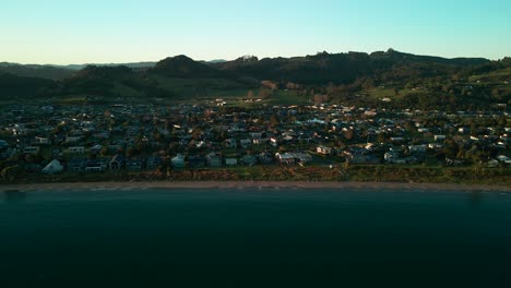 Drone-tripod-sitting-in-the-sky-watching-waves-roll-in-at-first-light