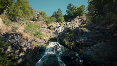 Aerial-rising-over-Todtnau-Waterfall-in-sunny-day,-Germany