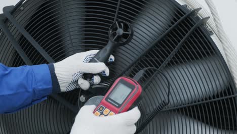 testing with an anemometer of an axial fan of the condensing unit