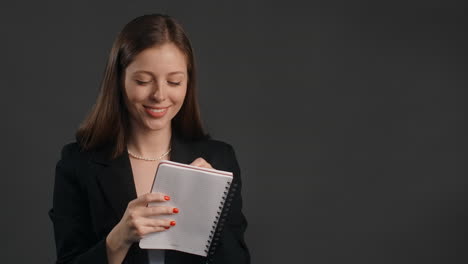 businesswoman writing in a notebook