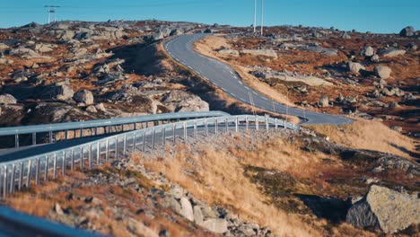 A-narrow-road-winds-through-the-autumn-tundra-valley