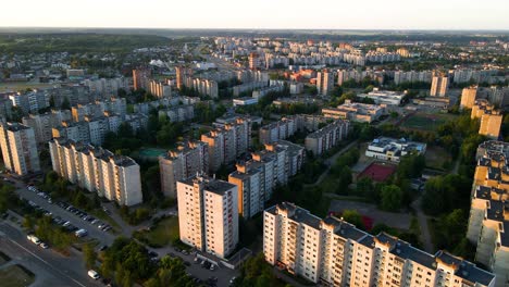 drone-shot-of-old-concrete-Soviet-apartment-houses-alongside-the-road-in-the-city-in-Kaunas,-Lithuania