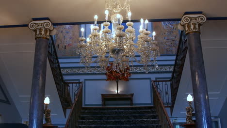 a chandelier in an opulent hotel manor house entrance hall lobby