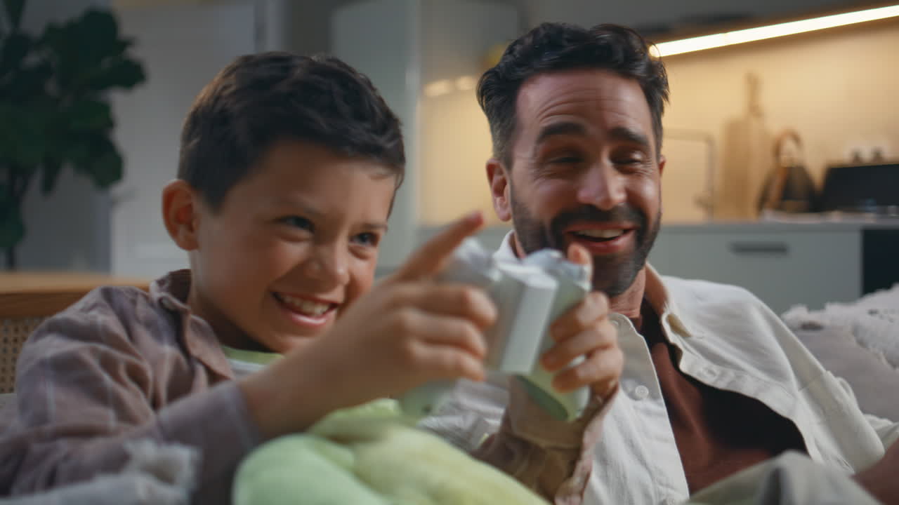 Video gaming family playing joysticks having fun together at evening closeup