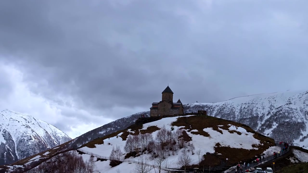 Aerial View Of Gergeti Trinity Church In Winter At Kazbegi, Oni, Georgia. - lateral shot