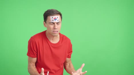 nervous man cheering for south korea during a match looking away