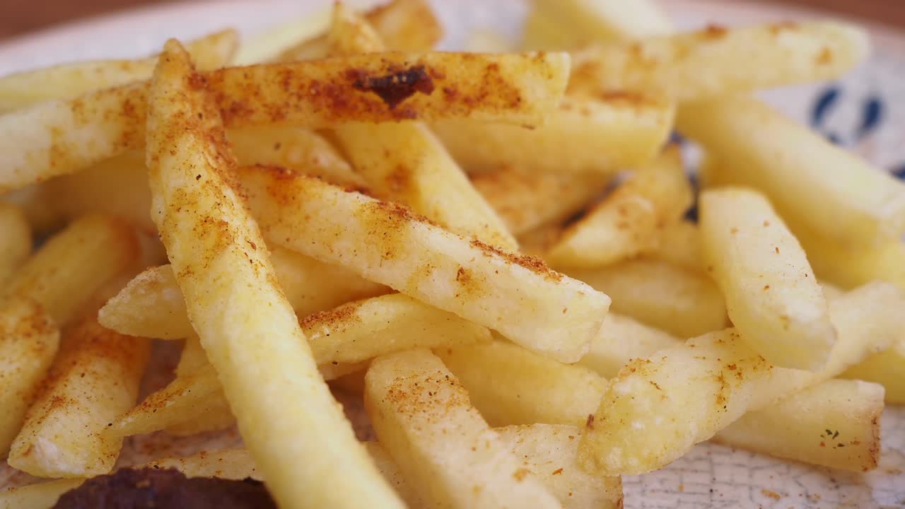 Close up of delicious golden french fries on a plate