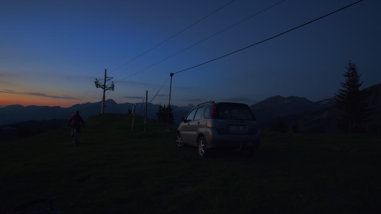 Mountain biker closes car boot and rides away at dawn