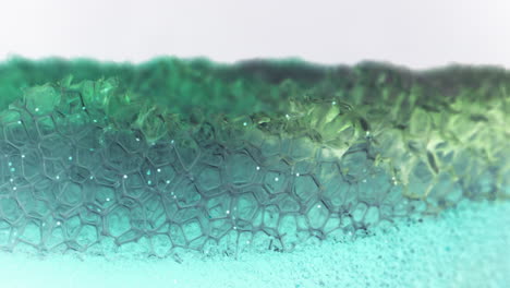 close-up view of a vibrant green and blue foam texture