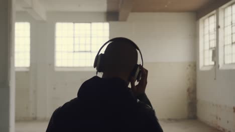 fashionable young man in an abandoned warehouse